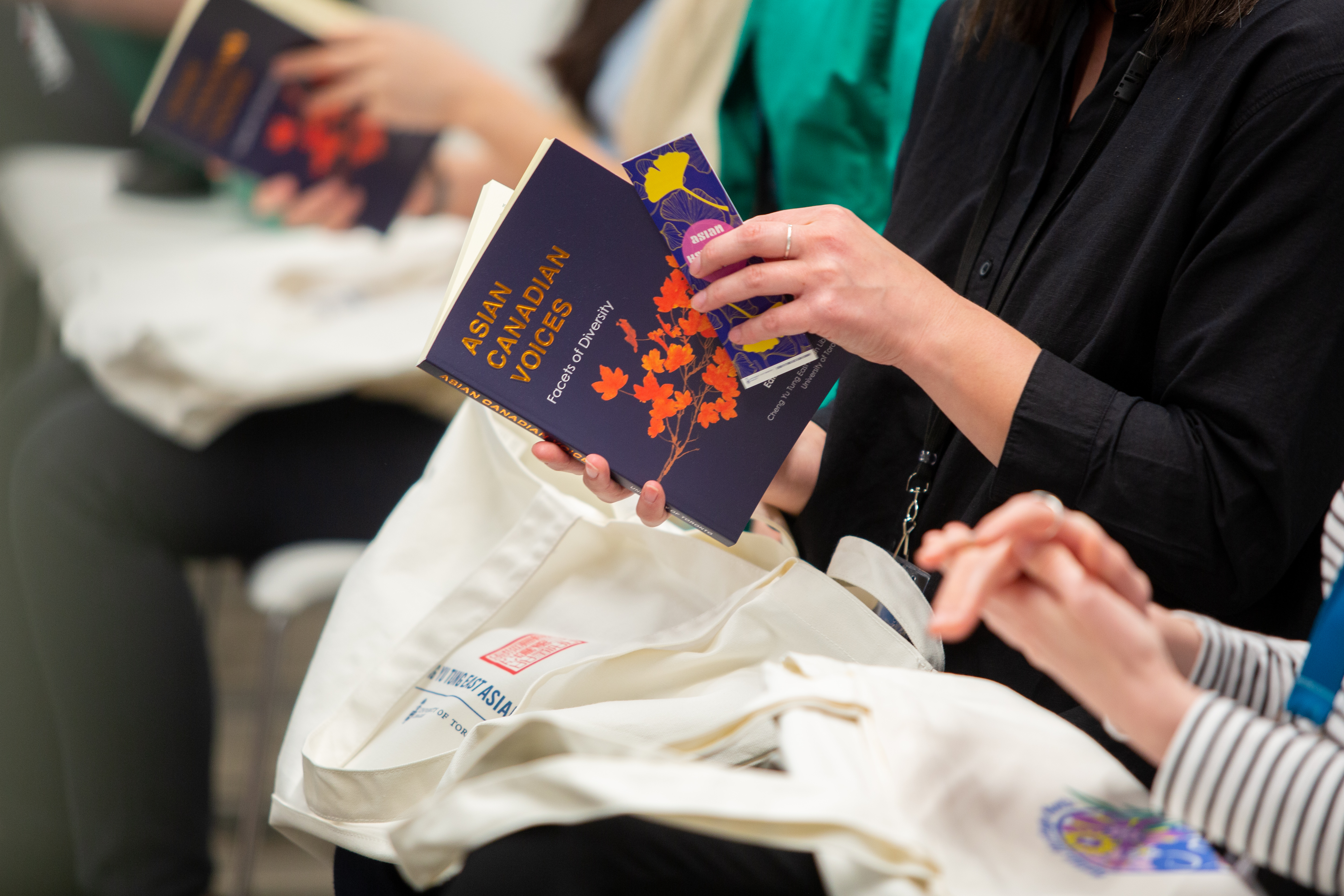 Audience members holding copies of the publication. 