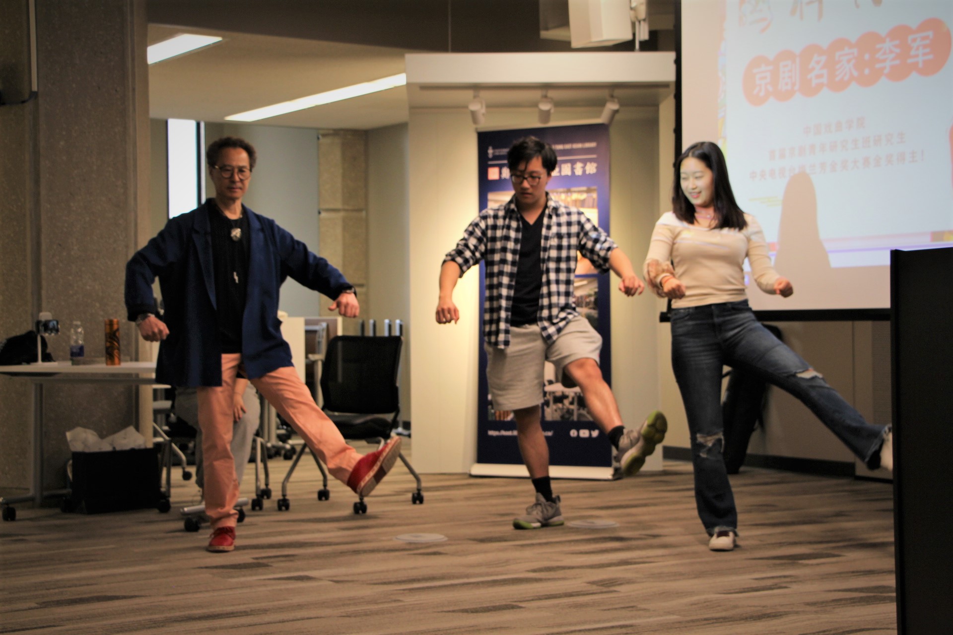 image description of Li Jun and two students dancing.